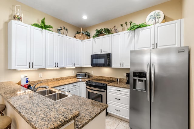 kitchen featuring white cabinets, kitchen peninsula, appliances with stainless steel finishes, and sink