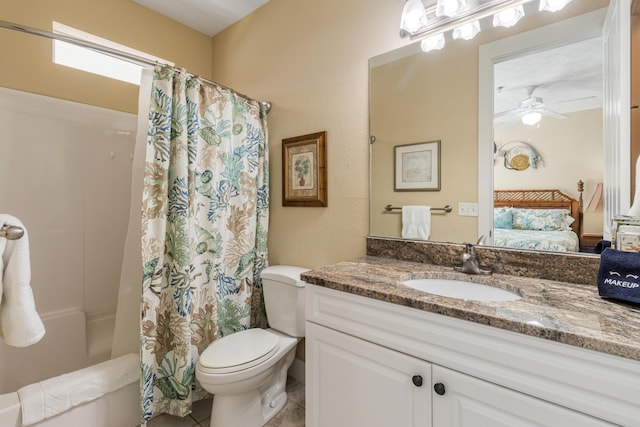 bathroom featuring tile patterned floors, vanity, a shower with curtain, toilet, and ceiling fan