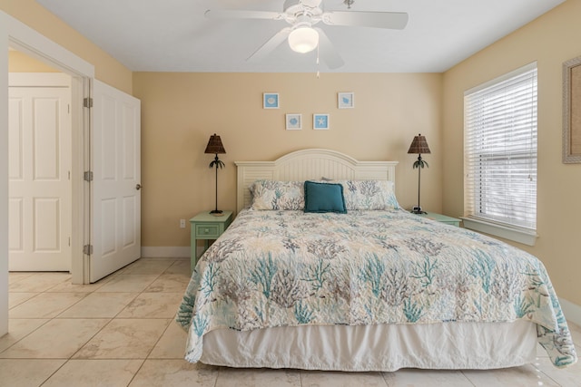 tiled bedroom with ceiling fan