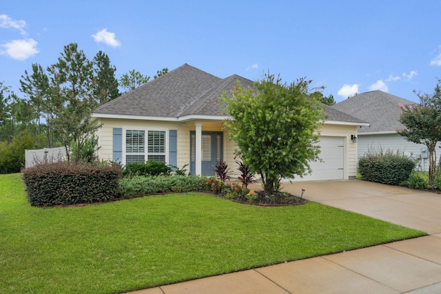 ranch-style house featuring a garage and a front yard