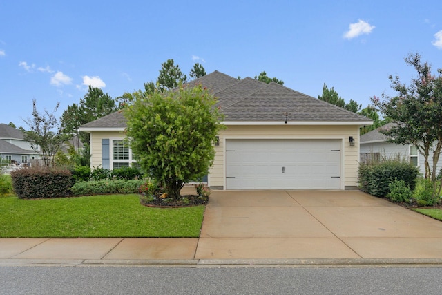 view of front of home with a front lawn and a garage