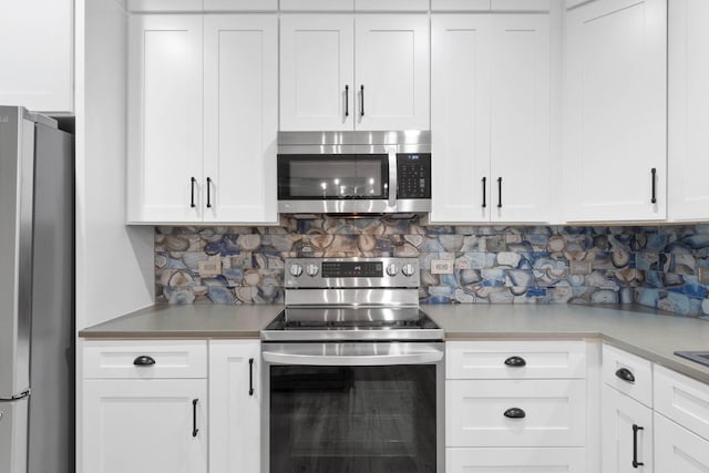 kitchen featuring appliances with stainless steel finishes, white cabinetry, and tasteful backsplash