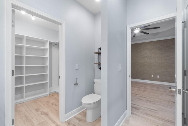 bathroom featuring toilet, ceiling fan, and hardwood / wood-style floors