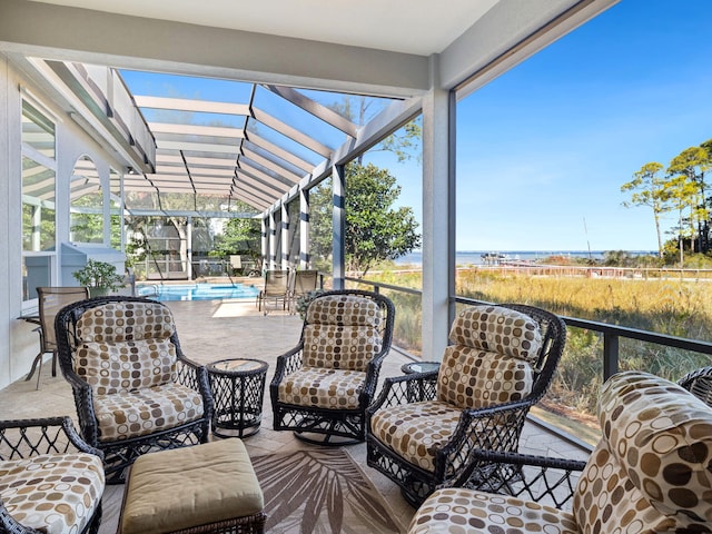 sunroom / solarium featuring a water view and vaulted ceiling