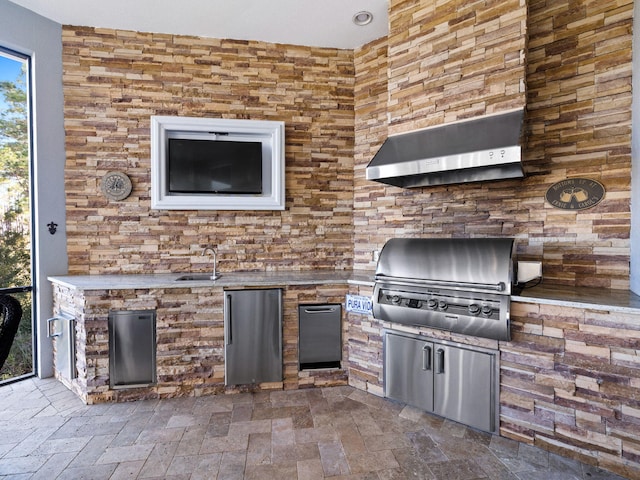 view of patio / terrace featuring a grill and an outdoor kitchen