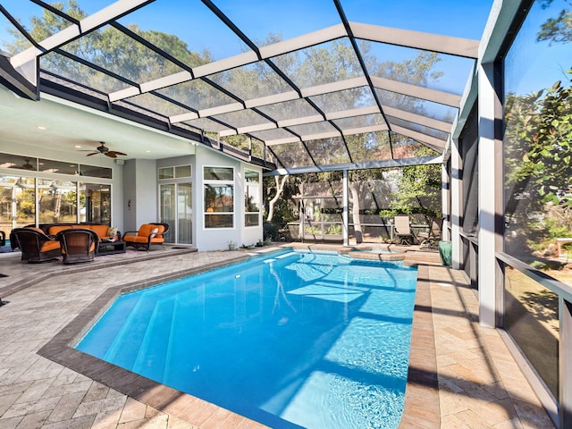 view of swimming pool featuring an outdoor living space, a lanai, a patio, and ceiling fan