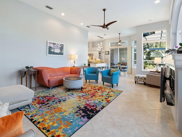 tiled living room with ceiling fan