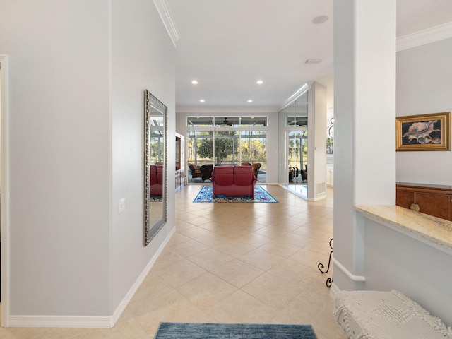 hall with crown molding and light tile patterned floors