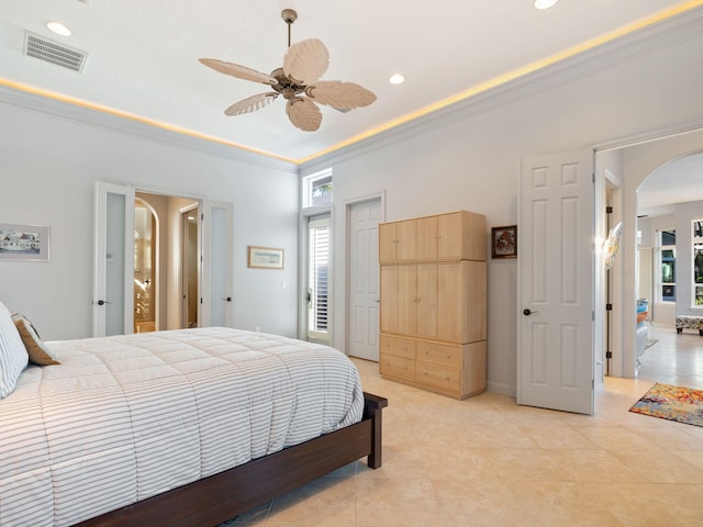 bedroom with multiple windows, ornamental molding, and ceiling fan