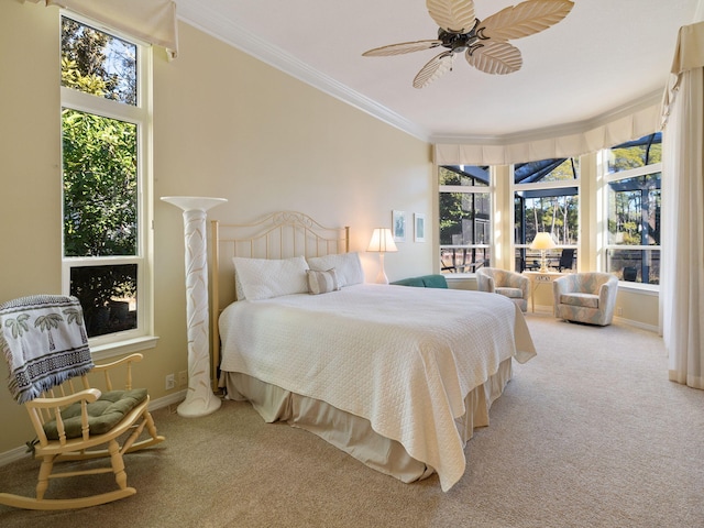 carpeted bedroom featuring multiple windows, crown molding, and ceiling fan