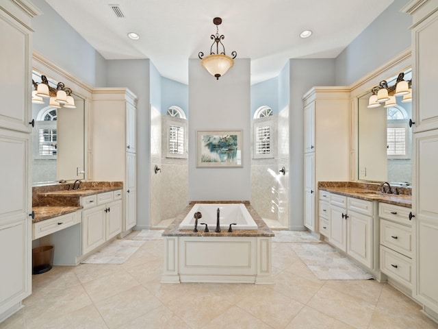 bathroom with vanity, tile patterned flooring, independent shower and bath, and tile walls