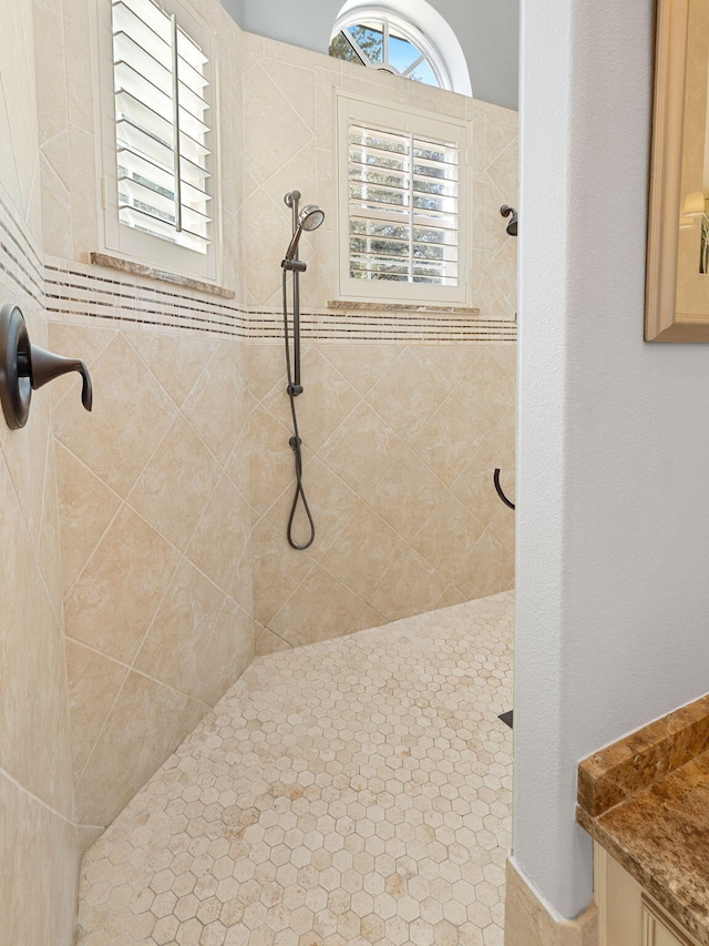 bathroom with tiled shower