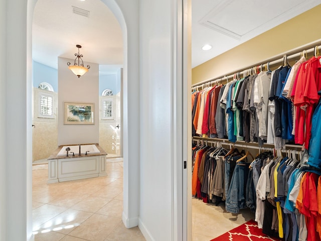 walk in closet with light tile patterned floors