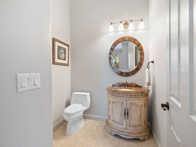 bathroom with vanity, toilet, and tile patterned flooring