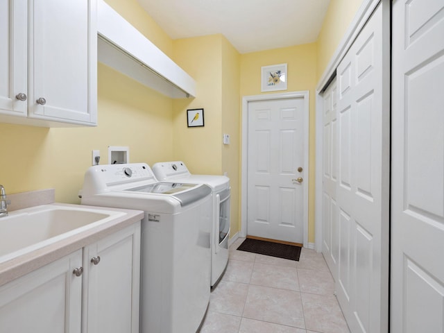 laundry area featuring cabinets, separate washer and dryer, sink, and light tile patterned floors