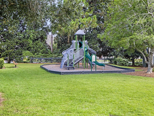 view of jungle gym featuring a lawn