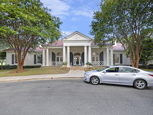 neoclassical home featuring a porch