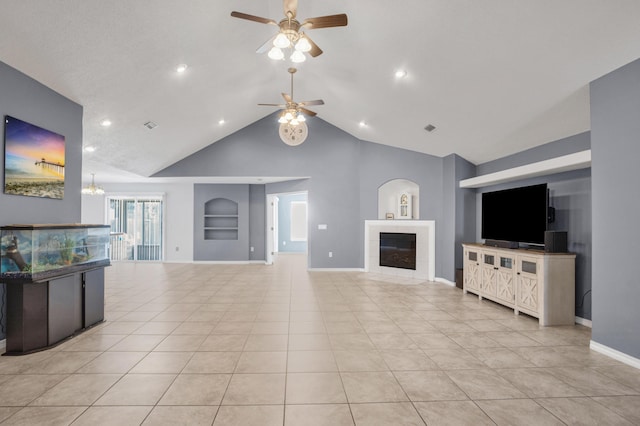 unfurnished living room with a fireplace, built in features, high vaulted ceiling, light tile patterned flooring, and ceiling fan with notable chandelier