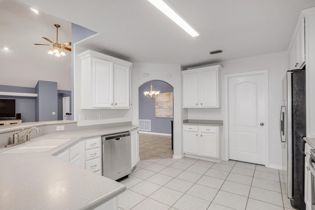 kitchen featuring sink, white cabinets, stainless steel appliances, and ceiling fan with notable chandelier