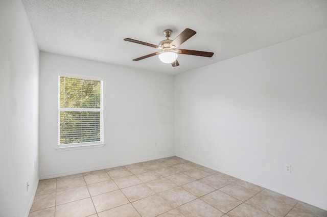 empty room with ceiling fan and a textured ceiling