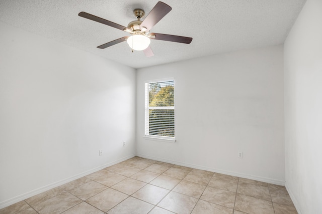 unfurnished room with a textured ceiling, ceiling fan, and light tile patterned floors