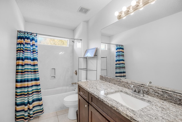 full bathroom with tile patterned floors, toilet, vanity, and a textured ceiling