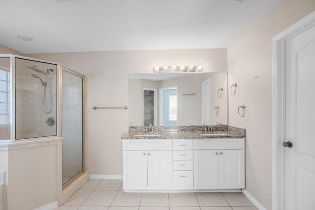 bathroom featuring tile patterned flooring, an enclosed shower, and vanity