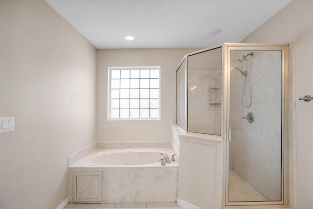 bathroom featuring shower with separate bathtub, tile patterned floors, and a textured ceiling