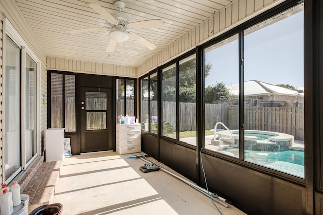 sunroom / solarium featuring ceiling fan