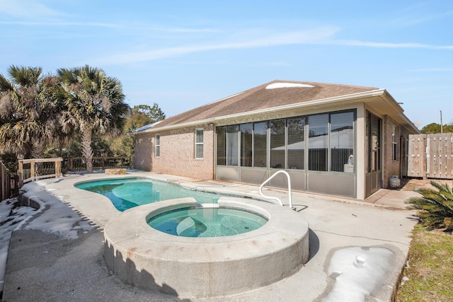 view of swimming pool with a patio and an in ground hot tub