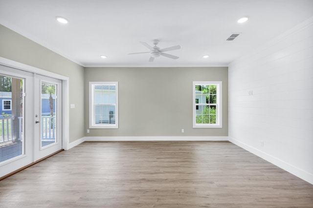 unfurnished room with french doors, ornamental molding, and light hardwood / wood-style flooring