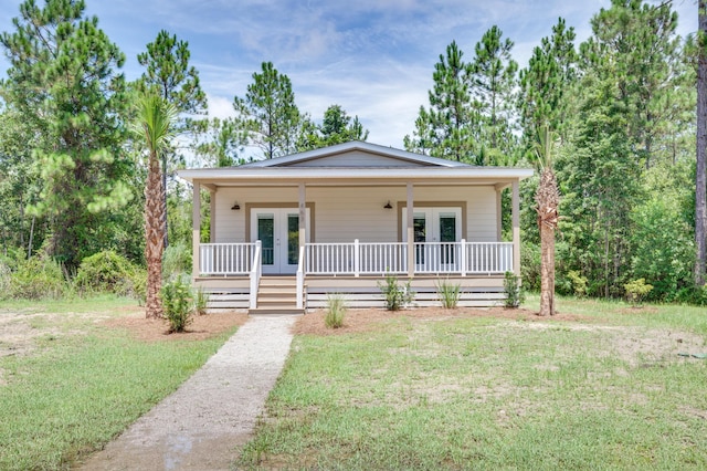 view of front facade featuring a front lawn and french doors