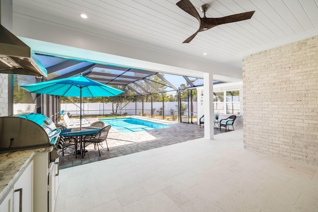 view of swimming pool with ceiling fan, a patio area, a lanai, and area for grilling