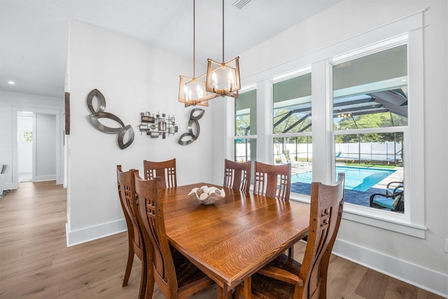 dining room featuring wood-type flooring and a notable chandelier