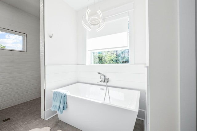 bathroom featuring tile patterned flooring and independent shower and bath