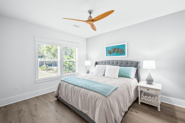 bedroom with ceiling fan and hardwood / wood-style flooring