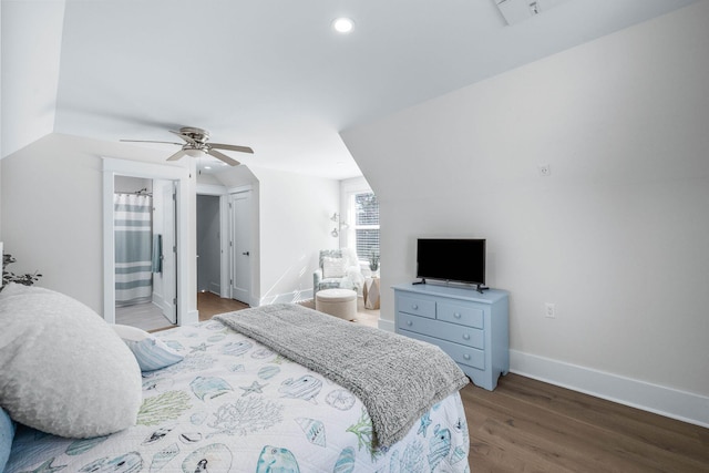 bedroom featuring ceiling fan, lofted ceiling, connected bathroom, and wood-type flooring