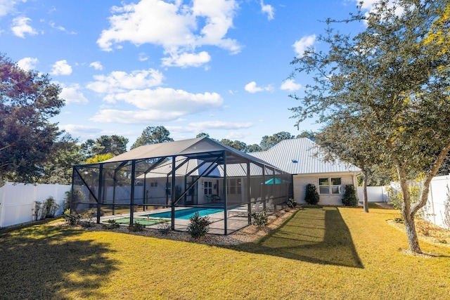 view of swimming pool with a lanai and a yard