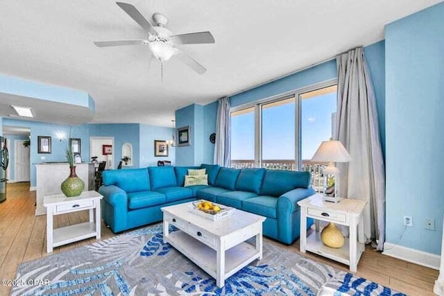 living room with ceiling fan and wood-type flooring