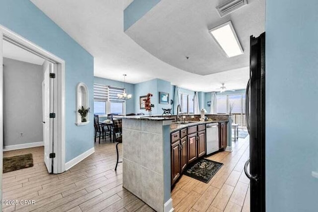 14825 Front Beach Rd Unit 2001, Panama City Beach, FL 32413 - kitchen featuring ceiling fan with notable chandelier, a kitchen bar, sink, a kitchen island with sink, and stainless steel dishwasher