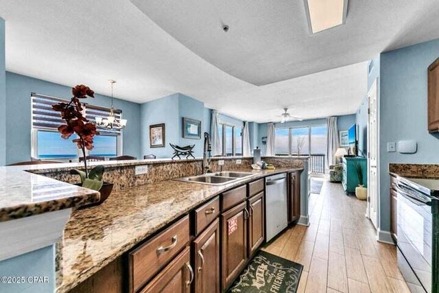 14825 Front Beach Rd Unit 2001, Panama City Beach, FL 32413 - kitchen featuring electric range, dishwasher, light stone countertops, pendant lighting, and sink