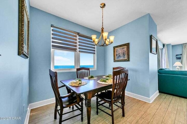14825 Front Beach Rd Unit 2001, Panama City Beach, FL 32413 - dining area featuring wood-type flooring and a notable chandelier