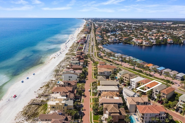 drone / aerial view featuring a water view and a view of the beach