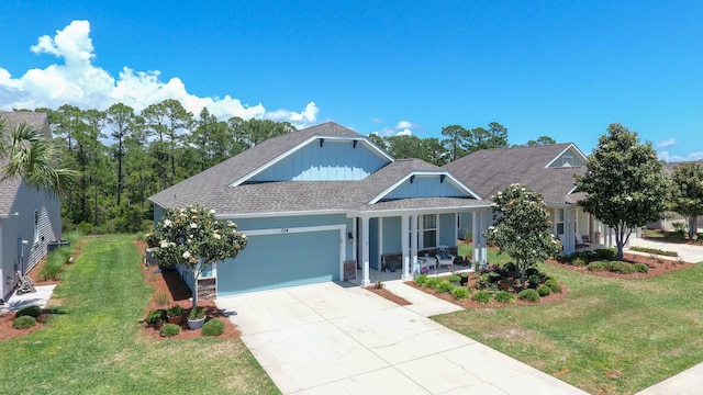 view of front facade featuring a garage, a front yard, and covered porch