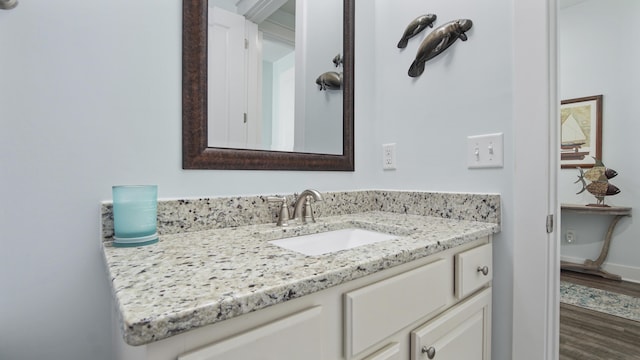 bathroom featuring vanity and hardwood / wood-style floors