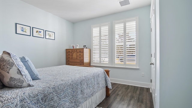 bedroom with dark hardwood / wood-style flooring