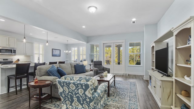 living room featuring dark hardwood / wood-style flooring and a notable chandelier