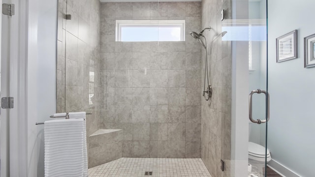 bathroom with walk in shower and toilet