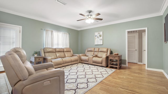 living room with crown molding, ceiling fan, and light wood-type flooring