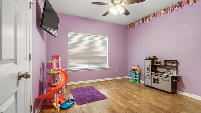 playroom featuring ceiling fan and light wood-type flooring